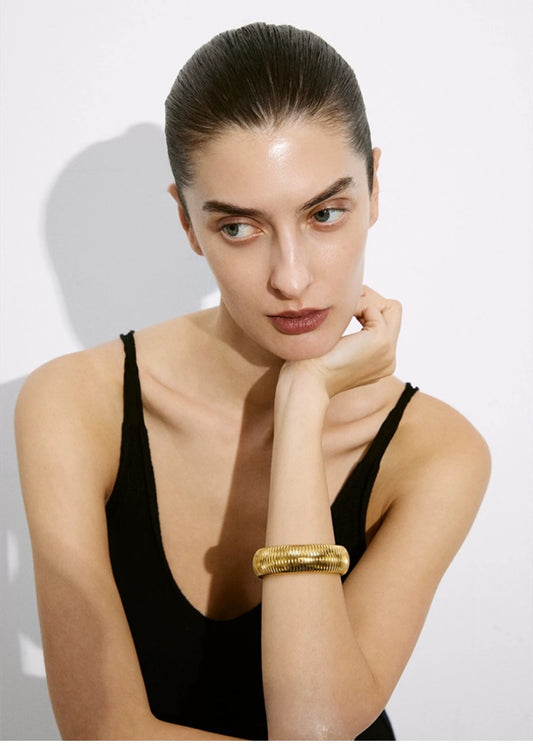 Model Wearing Elastic 18K gold plated snake chain bracelet – wide cuff design for women – STUD