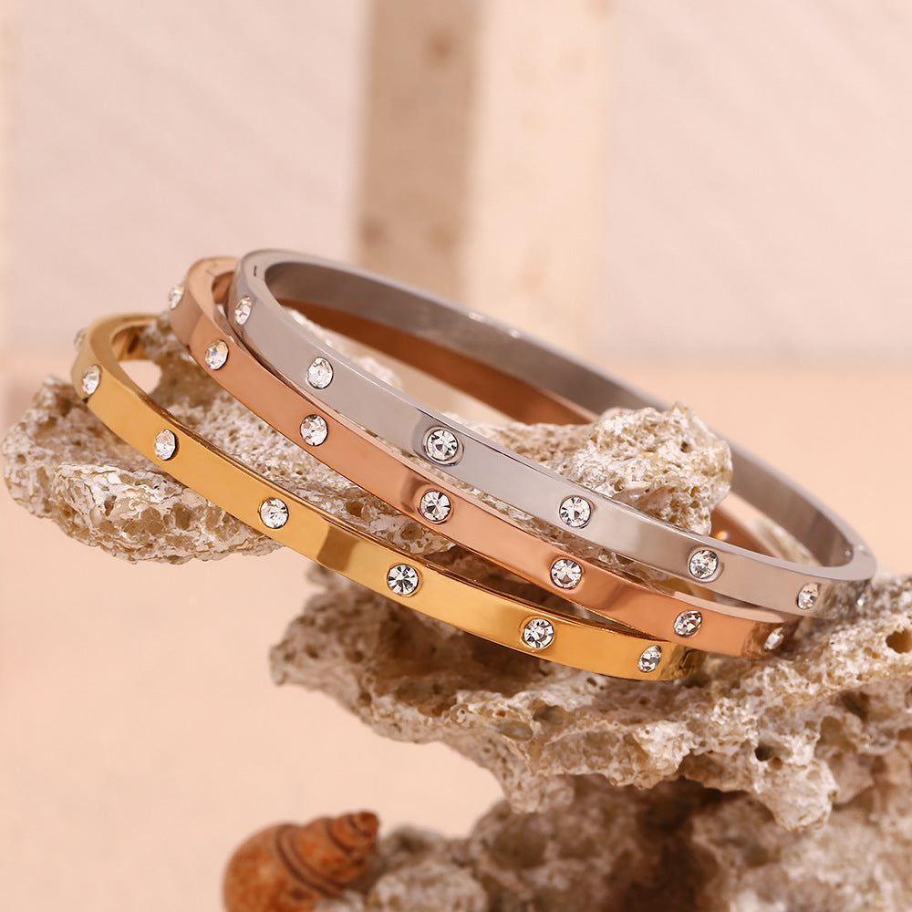 Silver stainless steel zircon bangle with round stones and snap-lock clasp – STUD
