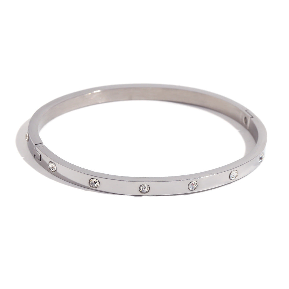 Silver stainless steel zircon bangle with round stones and snap-lock clasp – STUD