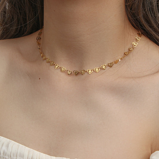 Model Wearing Elegant gold heart necklace with pearl detail – stainless steel design by STUD-Shop Till You Drop
