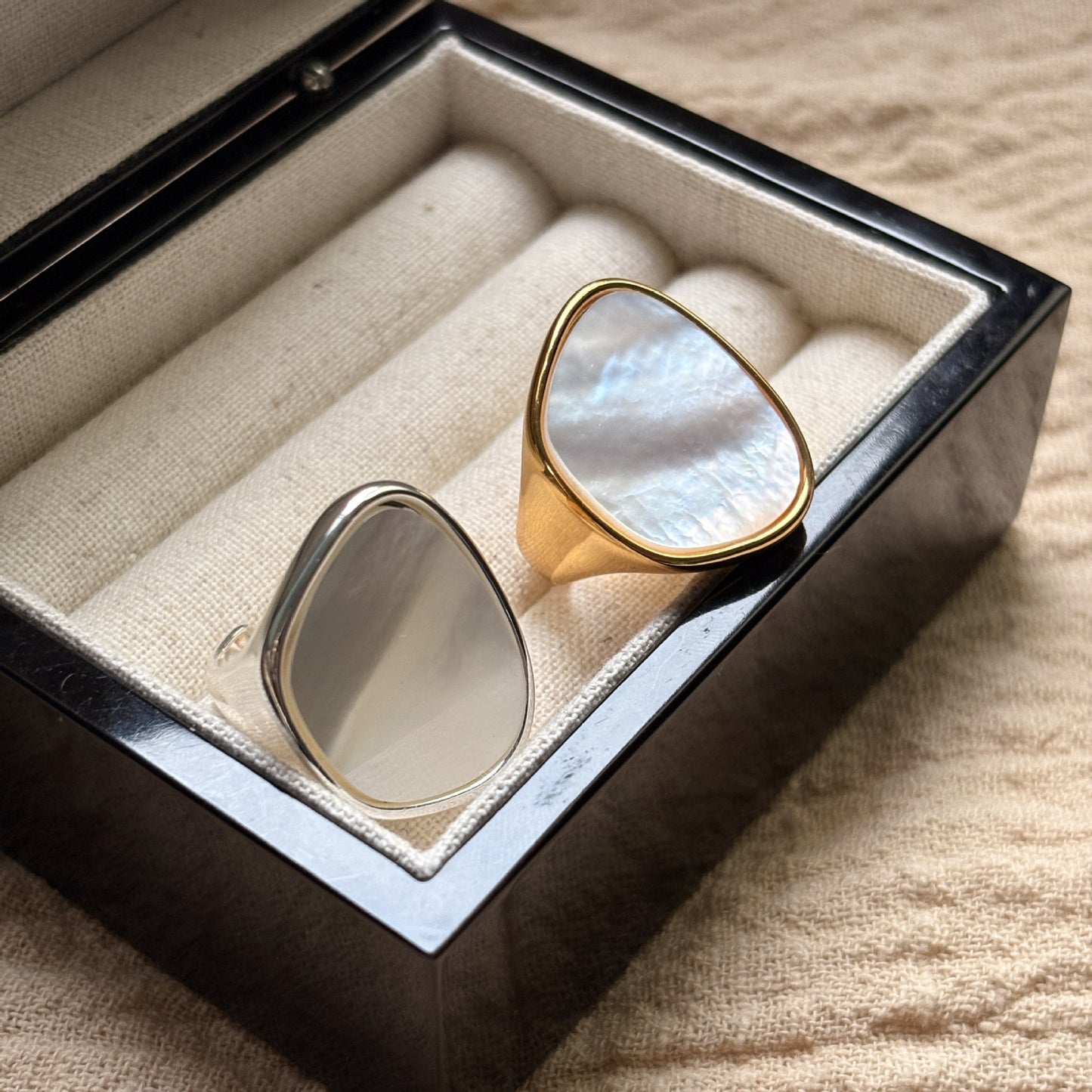 STUD Irregular Mother of Pearl Ring in Silver on neutral fabric with French text card