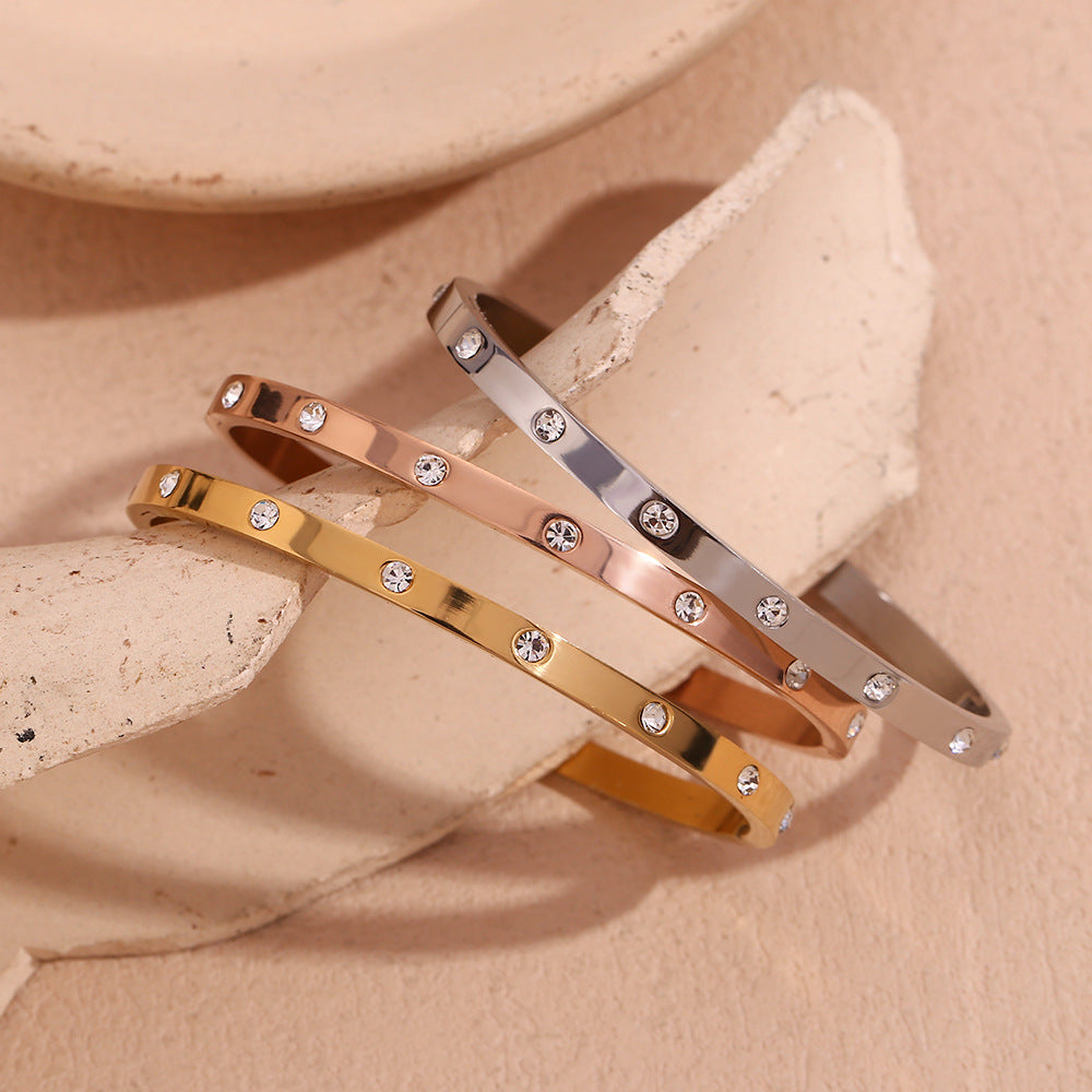 Silver stainless steel zircon bangle with round stones and snap-lock clasp – STUD