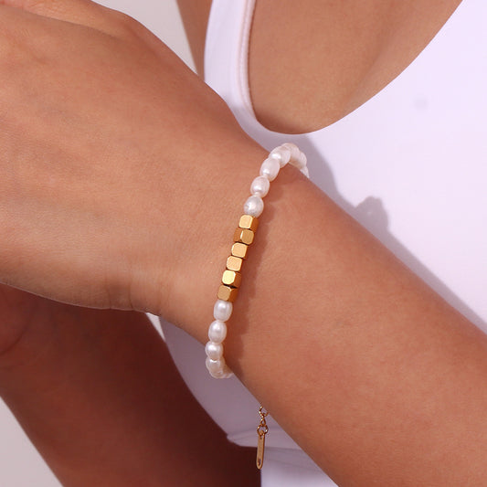 Model Wearing Minimalist stainless steel and freshwater pearl beaded bracelet – modern waterproof jewelry by STUD