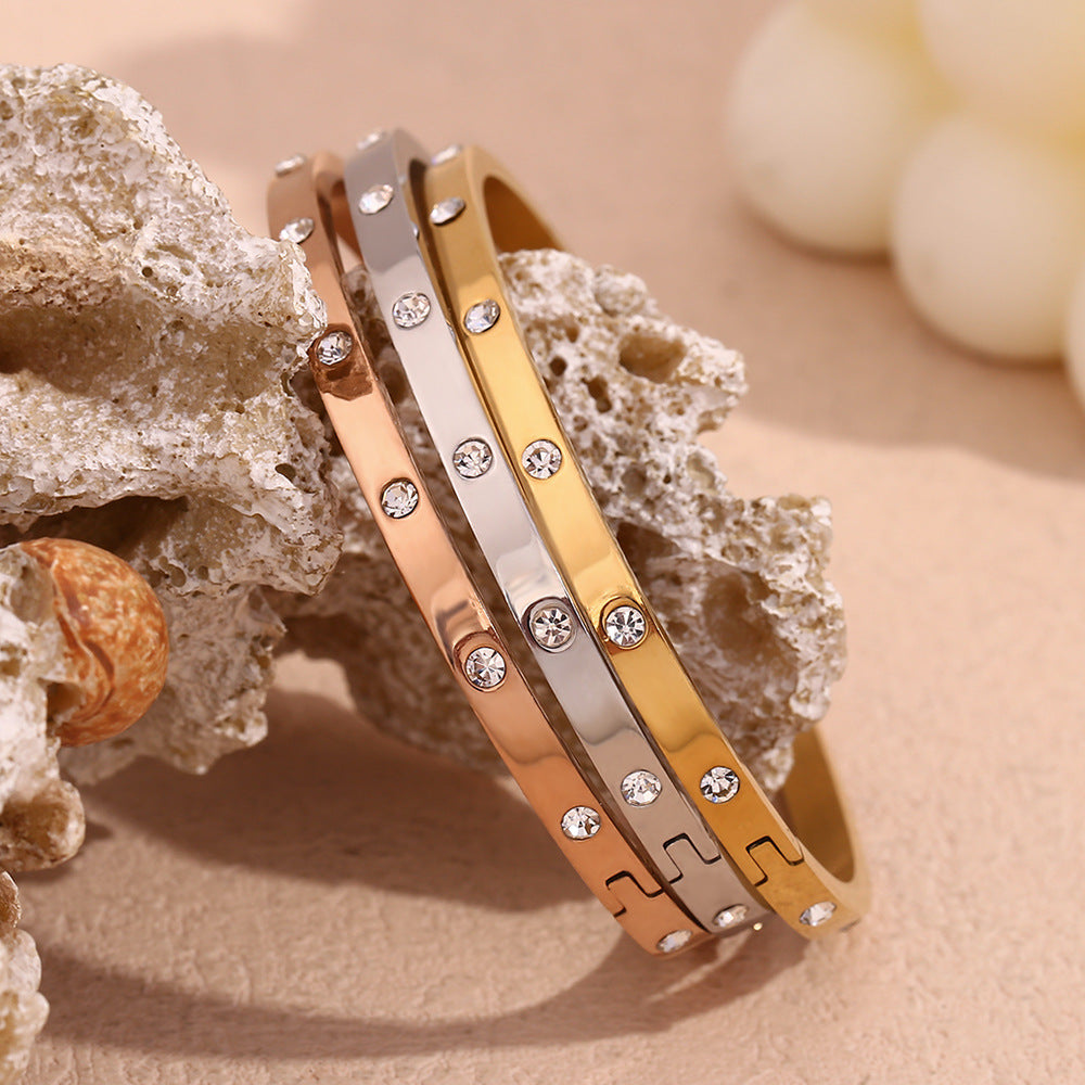 Silver stainless steel zircon bangle with round stones and snap-lock clasp – STUD
