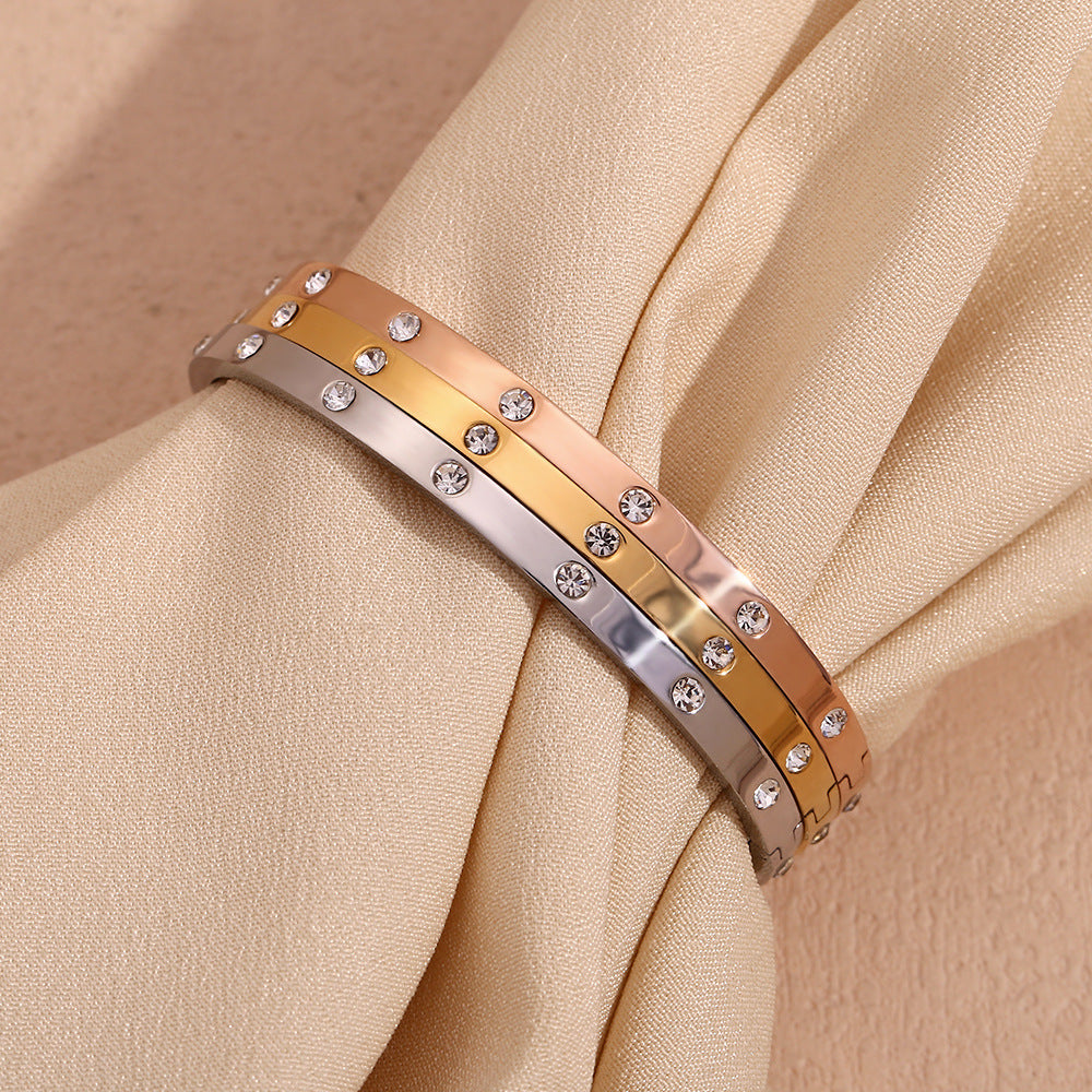 Silver stainless steel zircon bangle with round stones and snap-lock clasp – STUD