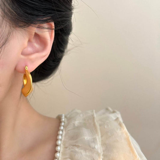 Matte gold handcrafted hoop earrings with irregular modern design by STUD