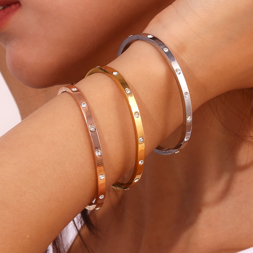 Silver stainless steel zircon bangle with round stones and snap-lock clasp – STUD