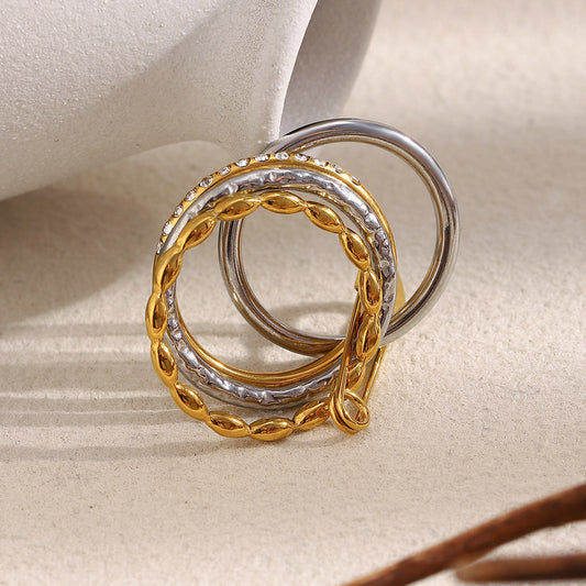 Stacked 18K gold and silver ring with zircon stones and safety pin design