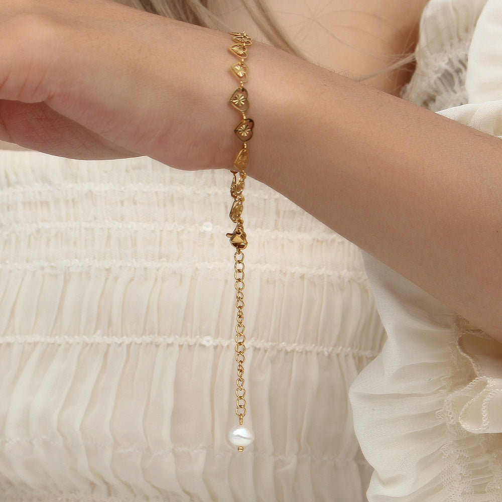 Model Wearing Heart bracelet with pearl accent – electroplated stainless steel design by STUD-Shop Till You Drop