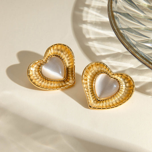 Close View of Heart-shaped gold earrings with white cat’s eye stone – 18K gold-plated, hypoallergenic by STUD (Shop Till You Drop)