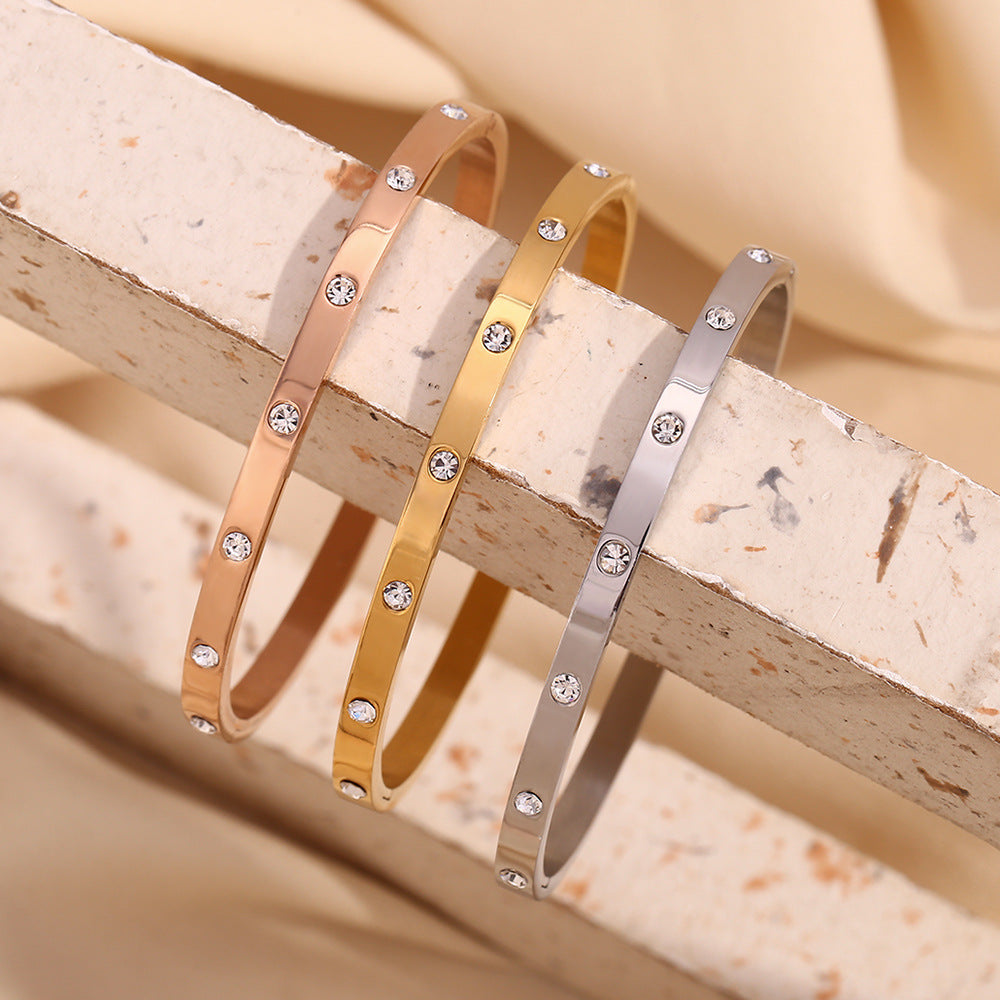 Silver stainless steel zircon bangle with round stones and snap-lock clasp – STUD