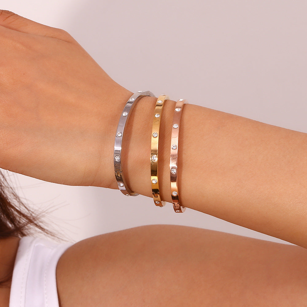 Silver stainless steel zircon bangle with round stones and snap-lock clasp – STUD