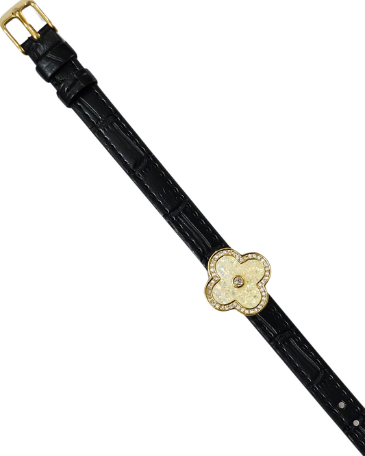 Black leather belt with a gold flower buckle on a white background