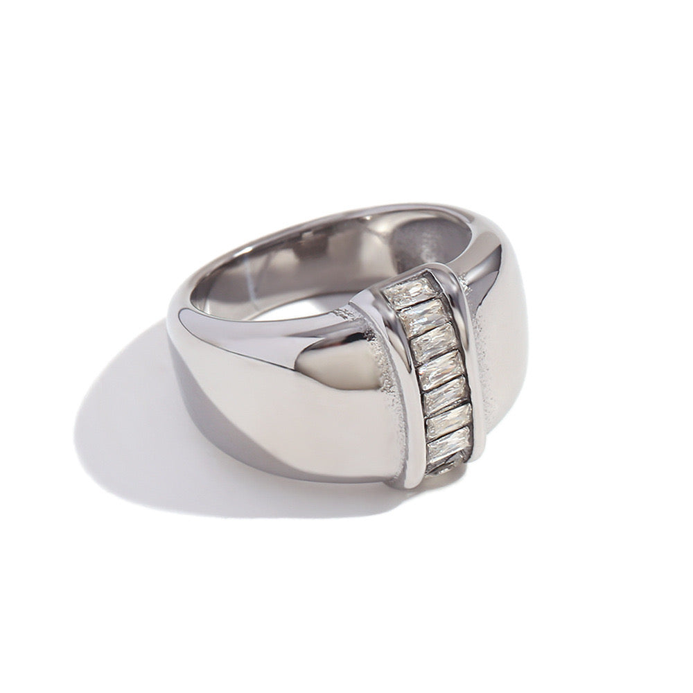 Silver Ring With A Diamond Set In The Center.