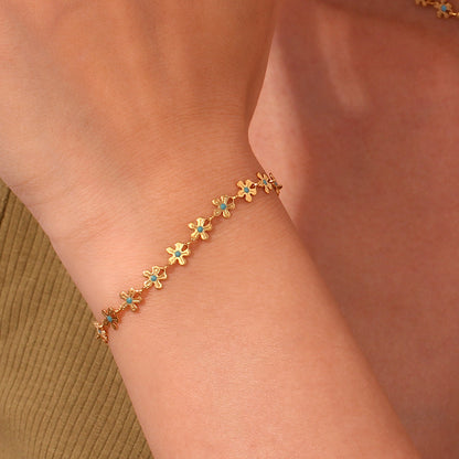 Model Wearing Retro blue flower bracelet – handcrafted 18K gold plated design by STUD-Shop Till You Drop