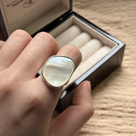STUD Irregular Mother of Pearl Ring in Silver on neutral fabric with French text card
