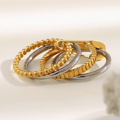 4-layer gold and silver ring with safety pin design, beaded and textured bands