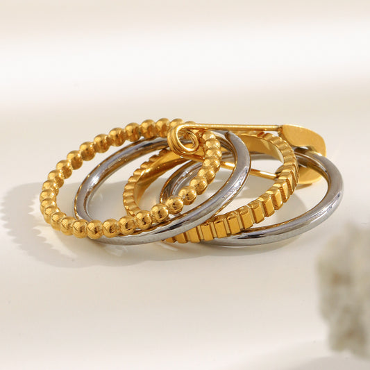 4-layer gold and silver ring with safety pin design, beaded and textured bands