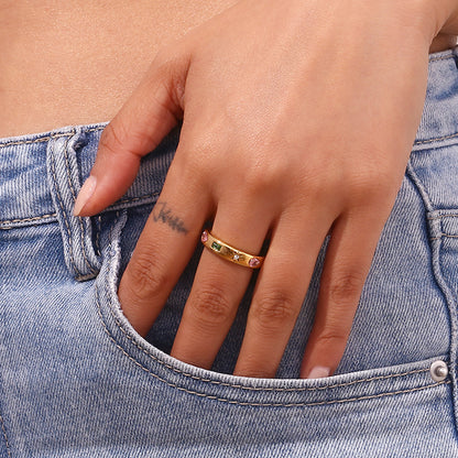 Close-up of geometric gold zircon ring