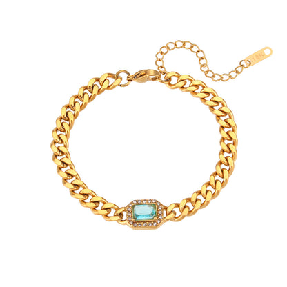 Close View of Bold Cuban link chain bracelet with blue zircon stone and pearl accent, 18K gold-plated and adjustable for a modern luxe look