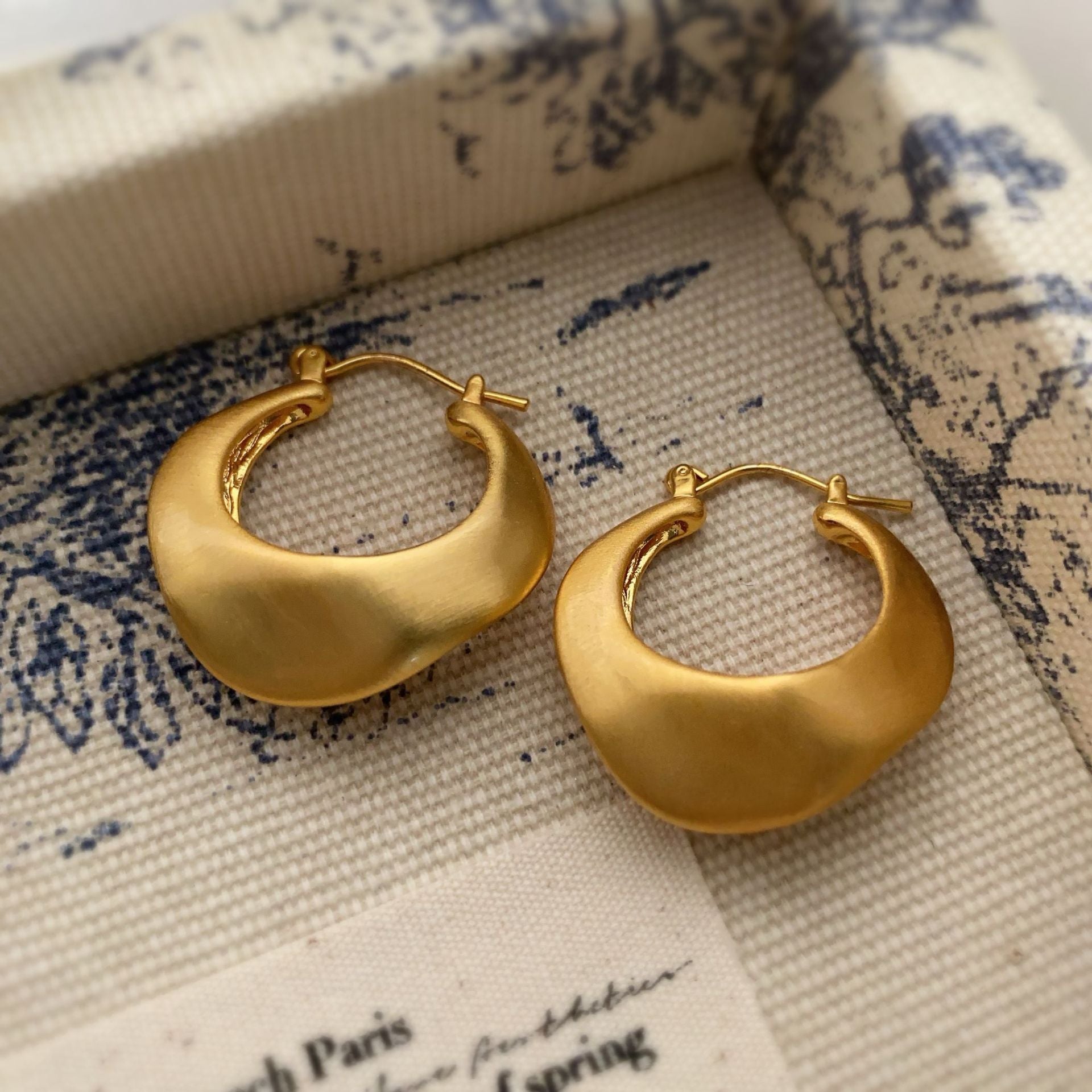 Matte gold handcrafted hoop earrings with irregular modern design by STUD