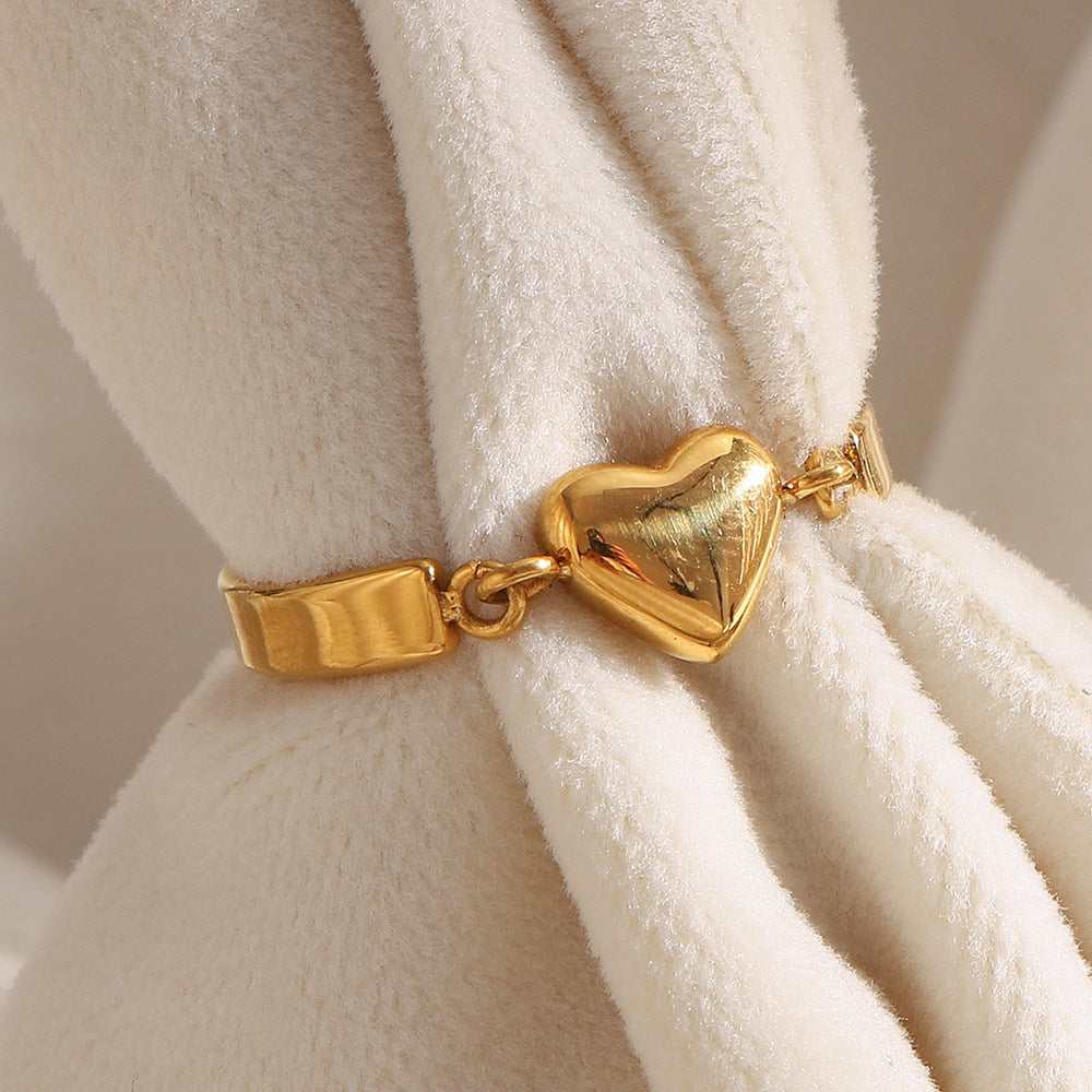 Gold heart ring with minimalist design and 18K gold-plated band