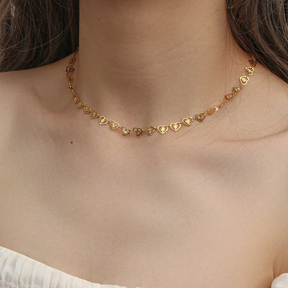 Model Wearing Elegant gold heart necklace with pearl detail – stainless steel design by STUD-Shop Till You Drop

