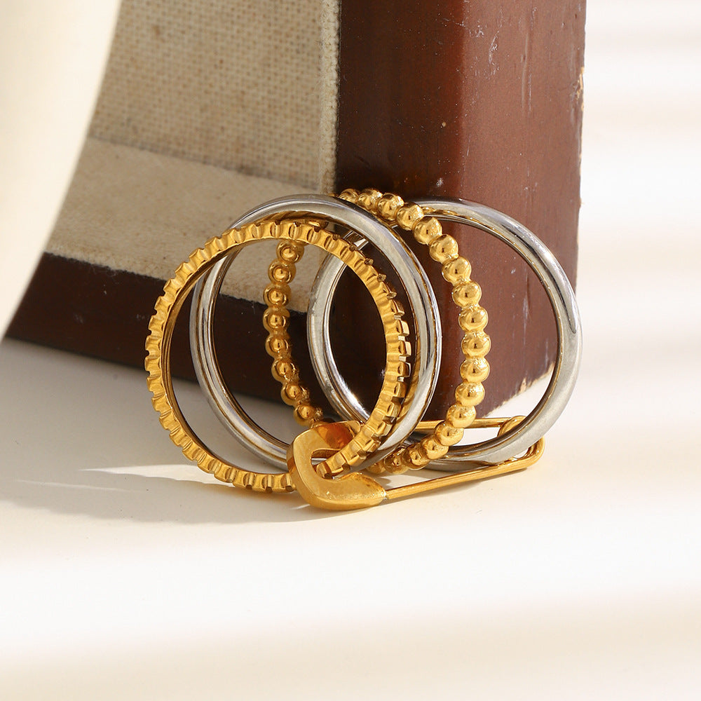 4-layer gold and silver ring with safety pin design, beaded and textured bands