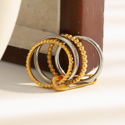 4-layer gold and silver ring with safety pin design, beaded and textured bands