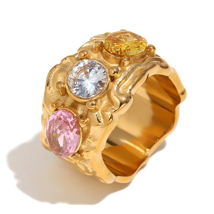 Chunky 18K gold-plated stainless steel ring with a raw sculpted texture and multicolor zircon detailing. A bold everyday statement.