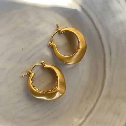 Matte gold handcrafted hoop earrings with irregular modern design by STUD