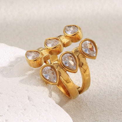 Bold 18K gold-plated open ring with double teardrop zircon stones on hammered stainless steel band – French statement design