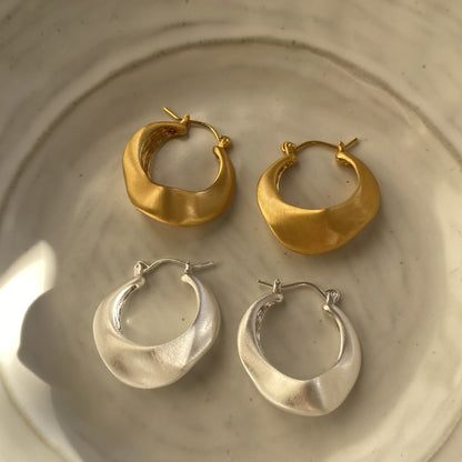 Matte gold handcrafted hoop earrings with irregular modern design by STUD