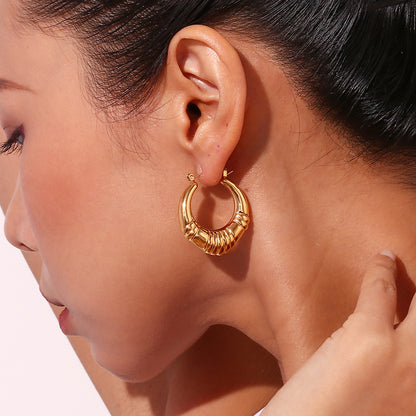 Model Wearing Vintage-inspired gold hoop earrings – 18K gold-plated triple-stripe, waterproof by STUD (Shop Till You Drop)