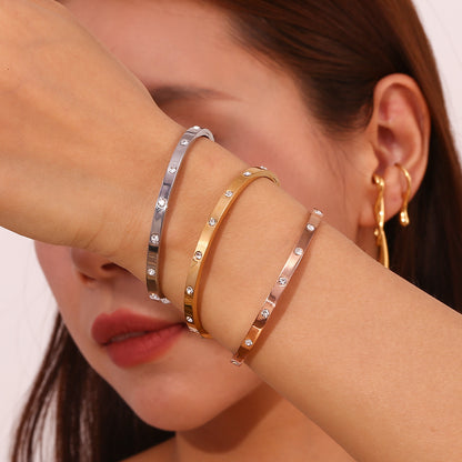 Silver stainless steel zircon bangle with round stones and snap-lock clasp – STUD