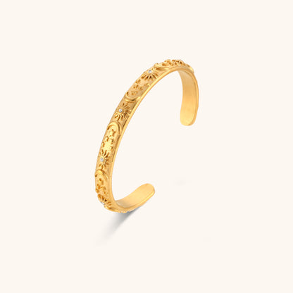 Close-up view of gold celestial bangle
