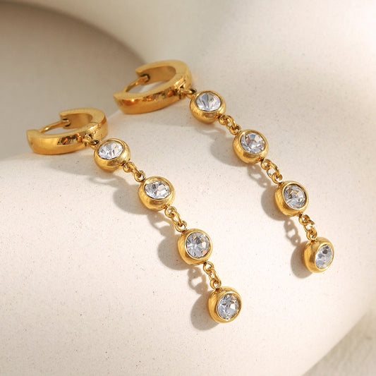 Gold-plated zircon tassel earrings by STUD – minimalist luxury with five sparkling zircon stones on each earring