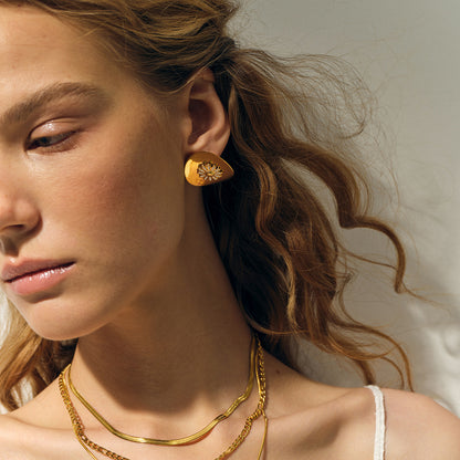 Model Wearing White enamel daisy earrings – floral studs on stainless steel, electroplated by STUD (Shop Till You Drop)