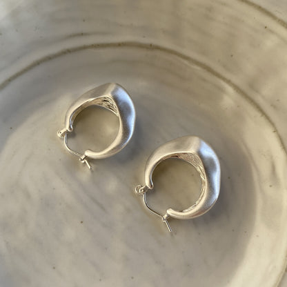 Brushed silver matte hoop earrings with modern irregular shape from STUD