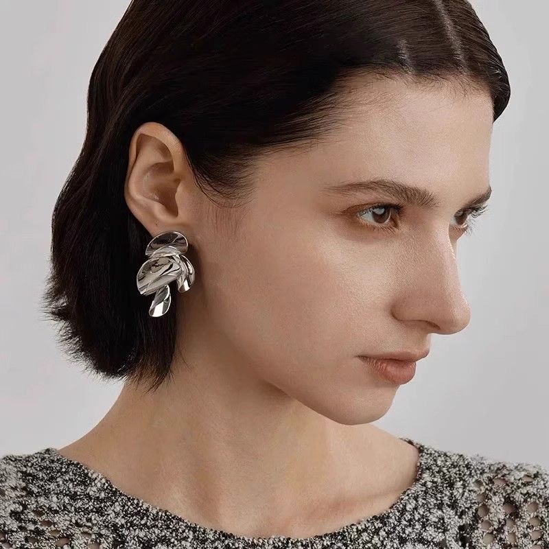 Close-up of twisted leaf stud earrings