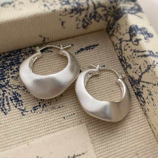Brushed silver matte hoop earrings with modern irregular shape from STUD