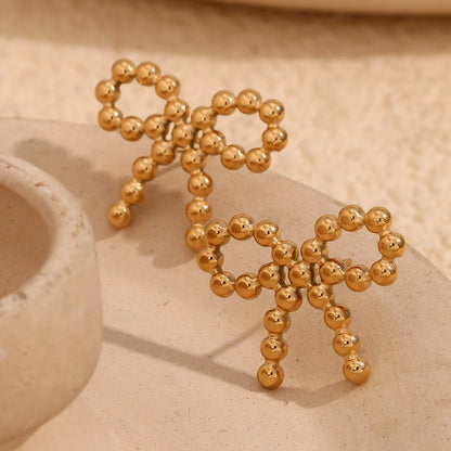 Close View of Gold bow knot earrings with round bead – 18K gold-plated, waterproof, hypoallergenic by STUD (Shop Till You Drop)