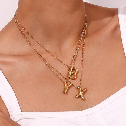 Model Wearing Balloon letter pendant necklace – 18K gold plated playful design by STUD-Shop Till You Drop