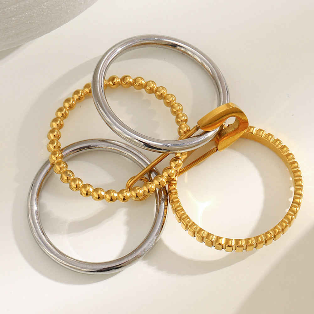 4-layer gold and silver ring with safety pin design, beaded and textured bands
