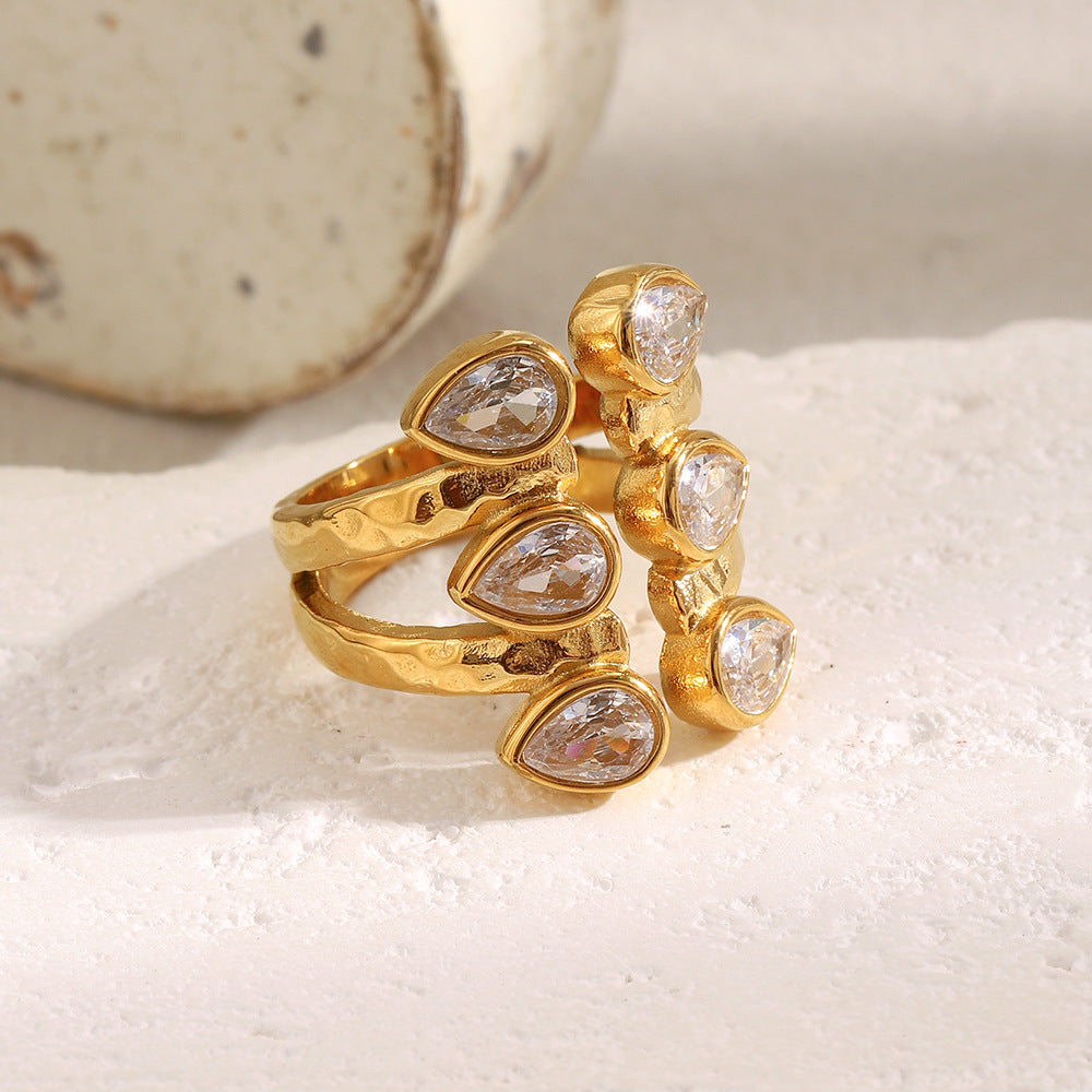 Bold 18K gold-plated open ring with double teardrop zircon stones on hammered stainless steel band – French statement design