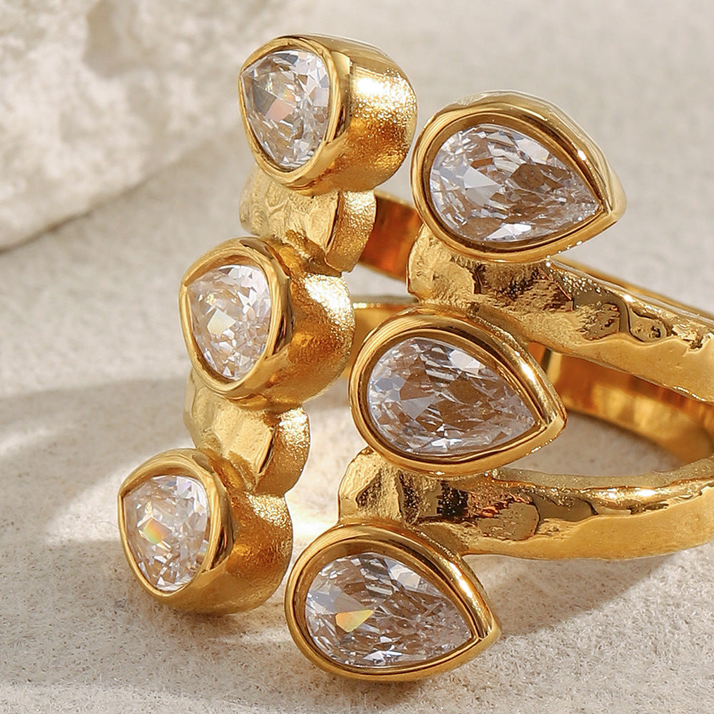 Bold 18K gold-plated open ring with double teardrop zircon stones on hammered stainless steel band – French statement design