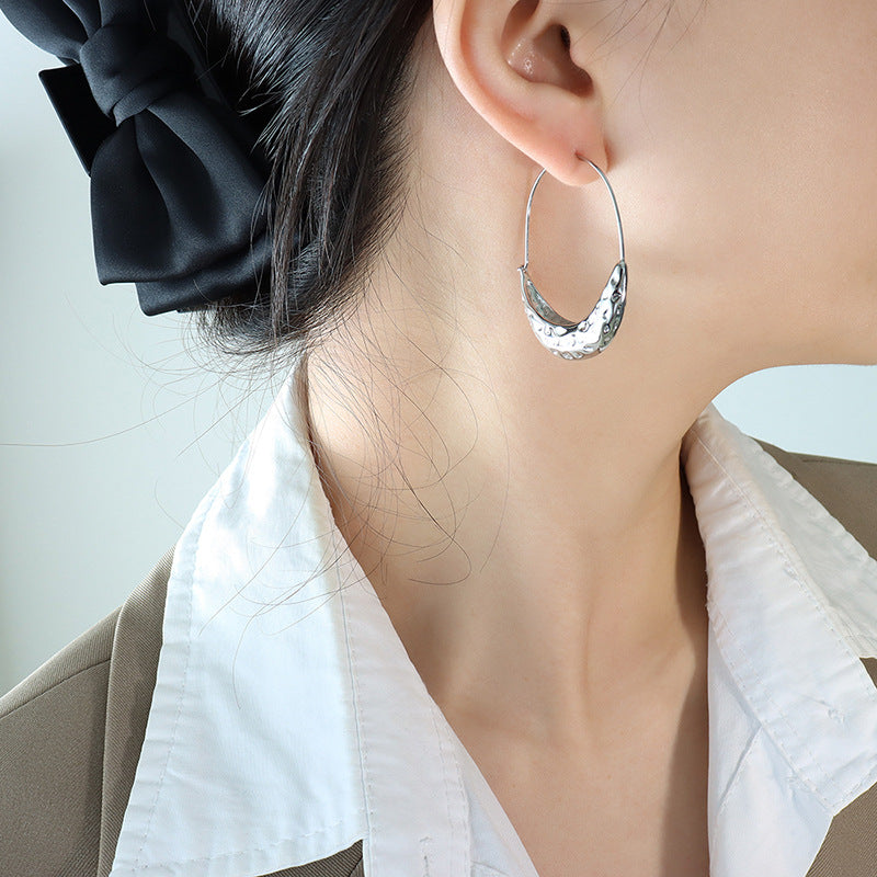 Gold-plated crescent hoop earrings with curved shape