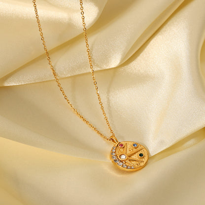 Gold compass pendant with stone accents