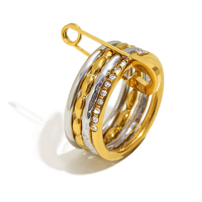 Stacked 18K gold and silver ring with zircon stones and safety pin design