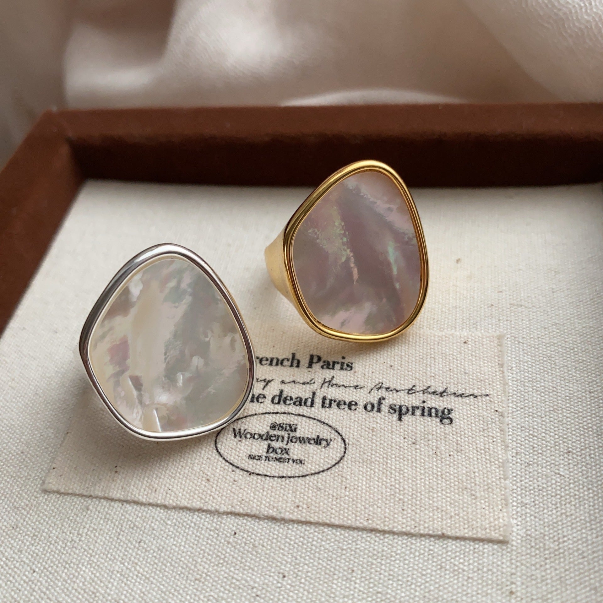 STUD Irregular Mother of Pearl Ring in Silver on neutral fabric with French text card